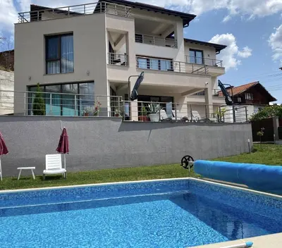 a house with a swimming pool in front of a house at The Hillside Villa in Ognyanovo