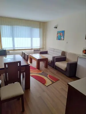 a living room with a couch and a table at Apartment near by Studenec-Cedar Heights 1 in Pamporovo