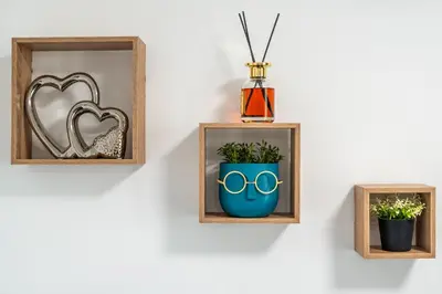 two frames with a mirror and a vase on a wall at Cardinal Suite in Sofia