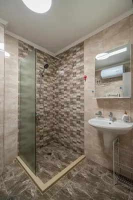 a bathroom with a shower and a sink at Cardinal Suite in Sofia
