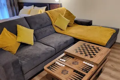a living room with a couch with a chess board at Diamond of Crown Bansko by Flat Mаnager in Bansko