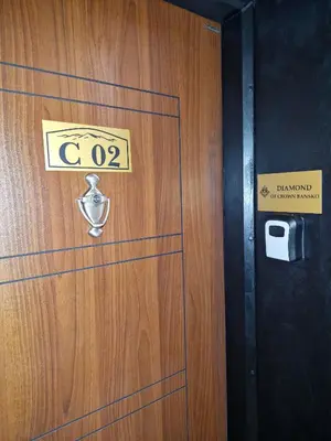 a wooden door with a sign on it at Diamond of Crown Bansko by Flat Mаnager in Bansko