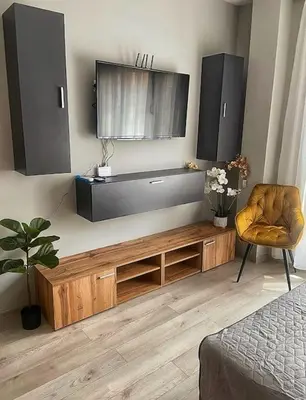 a living room with a tv and a chair at Бутиково студио Utopia in Plovdiv