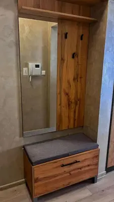 a bathroom with a wooden cabinet with a mirror at Бутиково студио Utopia in Plovdiv