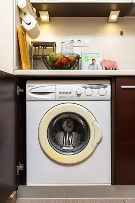 a washing machine in a kitchen with a bowl of fruit at Quiet Apartment in Plovdiv Ricky Home in Plovdiv