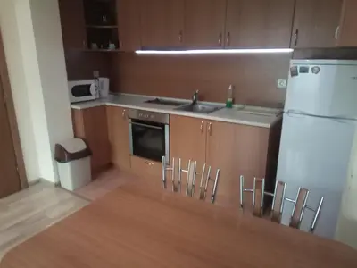a small kitchen with a sink and a refrigerator at Apartments Center in Sandanski