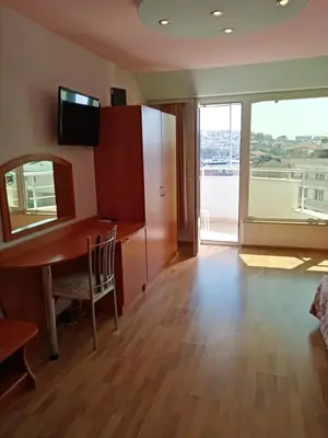 a room with a desk and a large window at Apartments Center in Sandanski