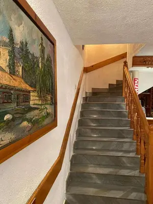 a staircase in a building with a painting on the wall at Matsureva House - Pri Ivan in Bansko