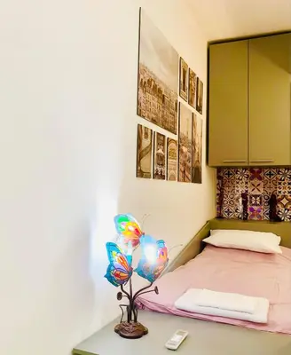 a bedroom with a bed and a table with a lamp at Little Paris with Free Garage Near Tokuda Hospital in Sofia