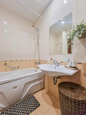a bathroom with a sink and a tub and a mirror at Cosy Apartment On The Lift in Bansko