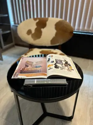 a table with a book on top of a chair at Business Park Sofia Cozy Lux & Private Garage Option in Sofia