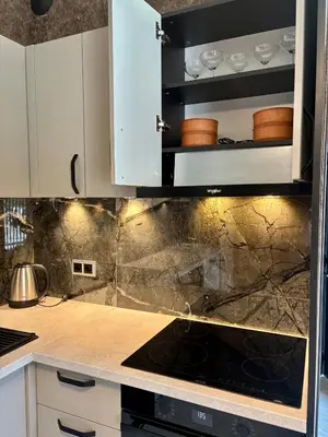 a kitchen with white cabinets and a stove top oven at Business Park Sofia Cozy Lux & Private Garage Option in Sofia