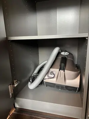 a cabinet with a vacuum and a phone in it at Business Park Sofia Cozy Lux & Private Garage Option in Sofia