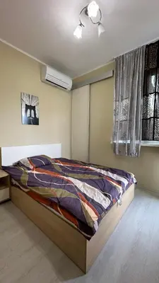 a bedroom with a bed and a window at Скобелев 48 in Sofia