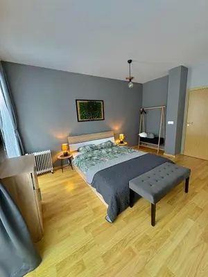 a bedroom with a bed and a bench in it at Bansko Cozy Peak in Bansko