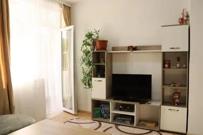 a living room with a tv on a shelf at Apartment Nataliya in Smolyan