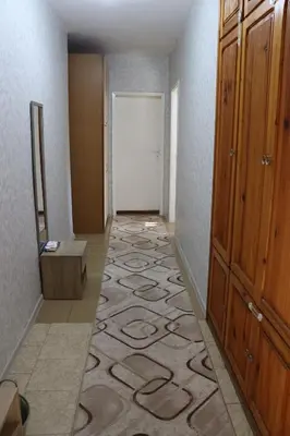 an empty hallway with a door and a carpet at Apartment Nataliya in Smolyan