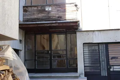 a building with a door with a sign on it at Apartment Nataliya in Smolyan