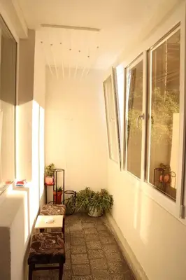 a small hallway with a bench and a window at Apartment Nataliya in Smolyan
