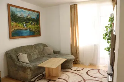 a living room with a couch and a table at Apartment Nataliya in Smolyan