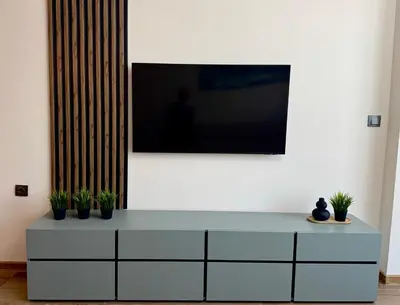 a white dresser with a television on a wall at Sun Home in the Heart of Plovdiv - Central Location - Free Private Parking in Plovdiv