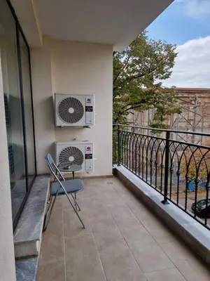 a balcony with a chair and an air conditioner at Sun Home in the Heart of Plovdiv - Central Location - Free Private Parking in Plovdiv