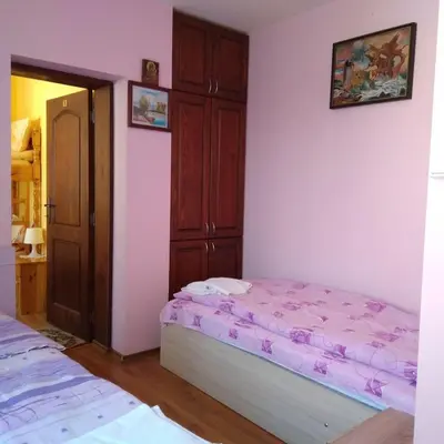 a bedroom with a bed and a closet at Tainov House in Samokov