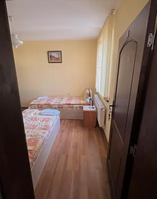 a small room with two beds and a window at Tainov House in Samokov