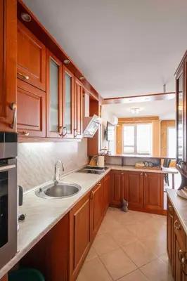 a kitchen with wooden cabinets and a sink at Vintage and Cozy 2BD Apartment in Prime Location by Flat Mаnager in Sofia
