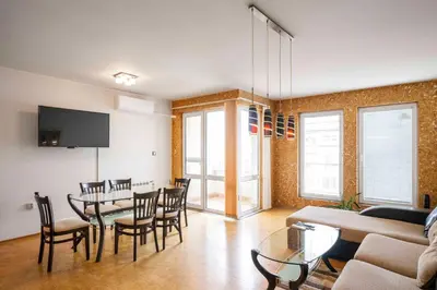 a living room with a table and chairs and a couch at Vintage and Cozy 2BD Apartment in Prime Location by Flat Mаnager in Sofia