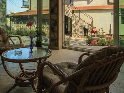 a table and two chairs and a table and a table at АПАРТАМЕНТ ЗА ГОСТИ 