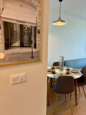 a dining room with a table and chairs and a mirror at MyCampus UNWE Studentski Mountain Views Modern Kitchen Equipment in Sofia