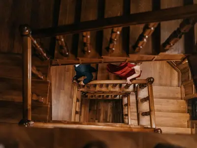 a man and woman standing on the stairs of a building at The Castle - Your unique way of retreat in Borovets
