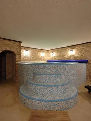 a lobby with a brick wall and stairs with lights at The Castle - Your unique way of retreat in Borovets