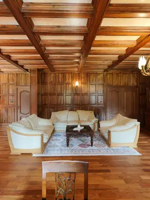 a living room with white furniture and a wooden ceiling at The Castle - Your unique way of retreat in Borovets