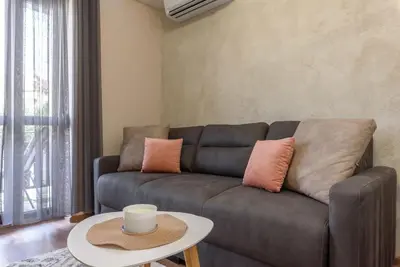 a living room with a brown couch and a table at Vutovi's corner made with care in Bansko