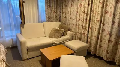 a living room with a chair and a coffee table at Cozy studio in Green Life Bansko in Bansko