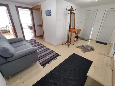 a living room with a couch and a mirror at Калиновата къща in Stoykite