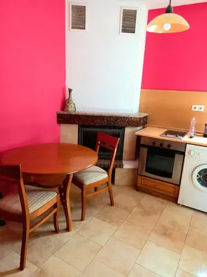 a kitchen with a table and a stove and a sink at Guest house Elora in Chiflik