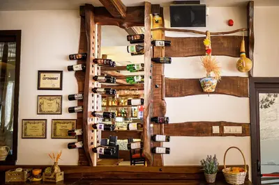 a wall of wine bottles in a room at Complex Jitari in Zhitnitsa