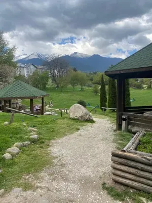 a path in a park with mountains in the background at Forest View Apartment C34 Bansko in Bansko