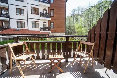 two chairs sitting on the balcony of a building at 650m Ski in&out - Studio - FREE SPA and Parking in Bansko