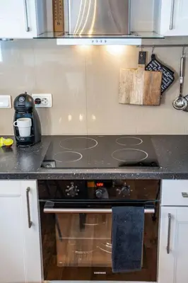 a kitchen with a stove and a counter top at Mountain Studio - Ski in and out - FREE Spa in Bansko