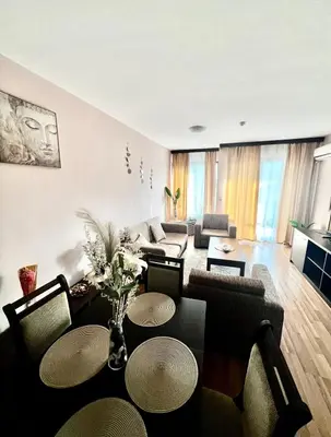 a living room with a couch and a table at Lorena Holiday Spa Свети Спас in Velingrad