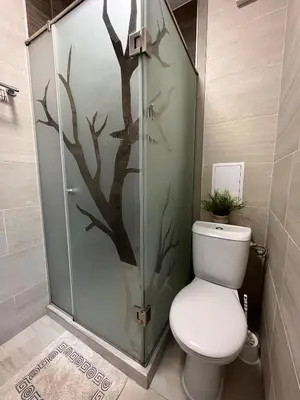 a bathroom with a shower with a toilet in it at Ideal Center by the Park - Walk to Kapana in Plovdiv