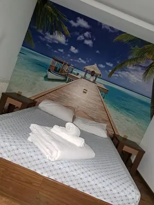 a bedroom with a mural of the ocean at Комплекс Тракийски стан in Asenovgrad