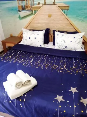 a bed with white towels and stars on it at Комплекс Тракийски стан in Asenovgrad