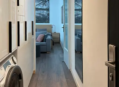 a hallway with a couch and a living room at Chill Out Urban Studio in Plovdiv