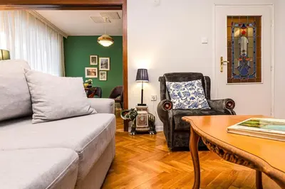 a living room with a couch and a table at Central Family Apt Fuzzy Muzzy 2 bedrooms MU University in Plovdiv