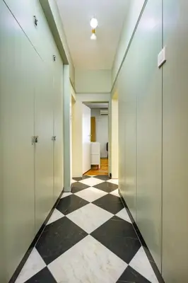 a hallway with a black and white checkered floor at Central Family Apt Fuzzy Muzzy 2 bedrooms MU University in Plovdiv